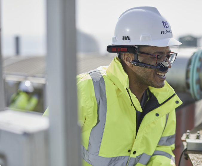 A man wearing a hardhat and high visibility jacket