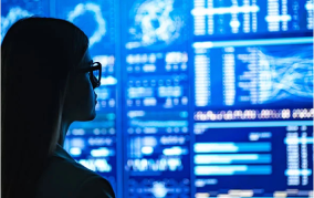 A woman looking at a large digital display
