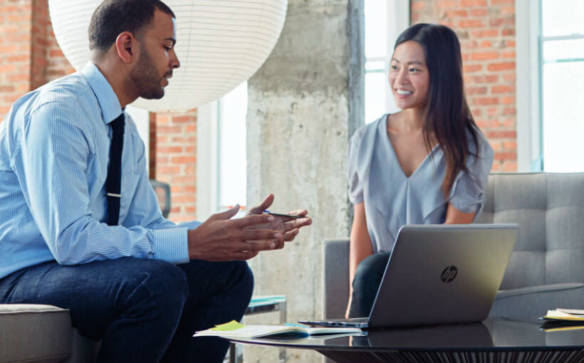 Two people sitting down, in discussion