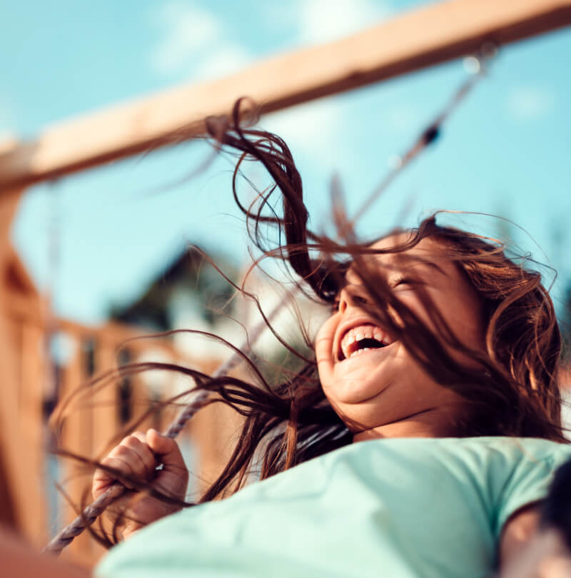 A happy girl on a swing