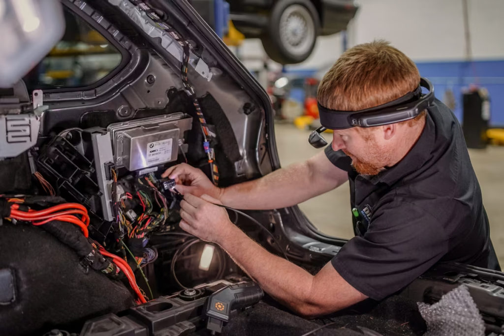 A mechanic using a Realwear headset