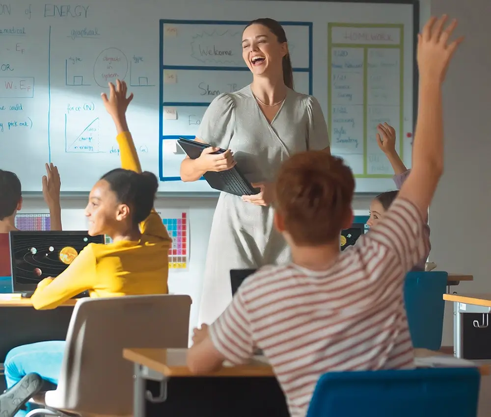 A happy teacher and students in a classroom